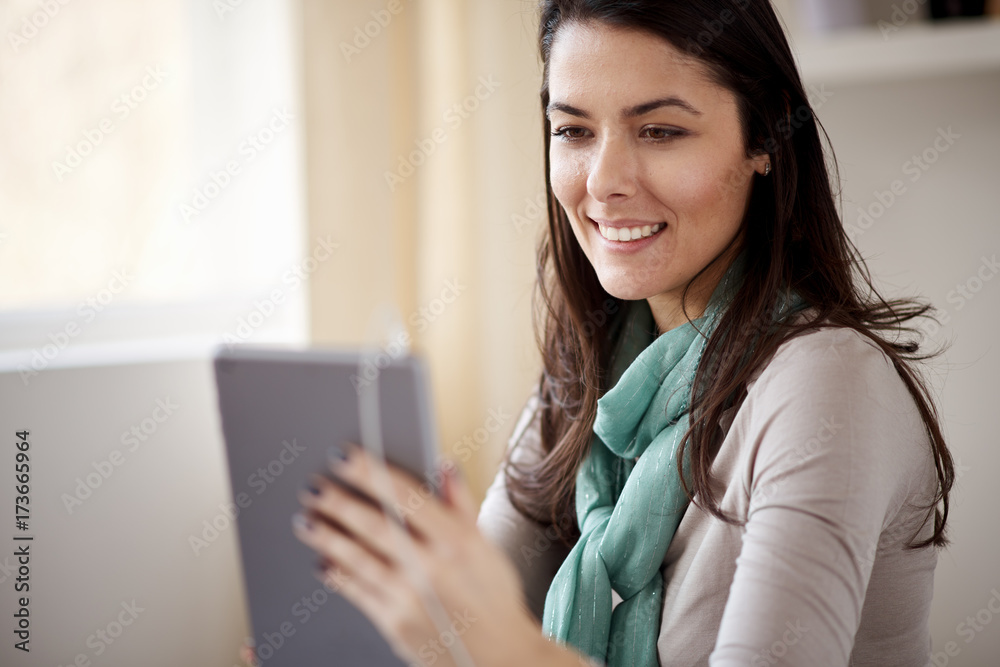 Businesswoman using tablet device at home office/ self employ woman in thirties Businesswoman using tablet device at home office/ self employ woman in thirties