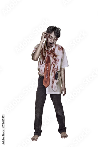 Portrait of creepy asian zombie man in clothes with blood photo