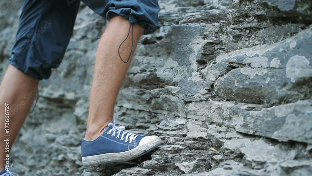 Young man on a rock climbing Young man on a rock climbing