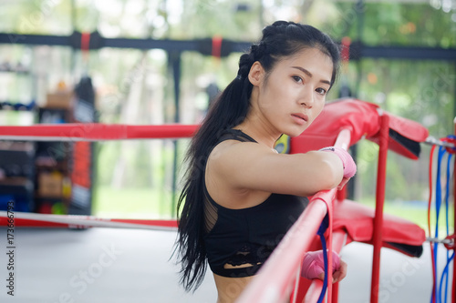Portrait asian woman on ringside boxing gym.