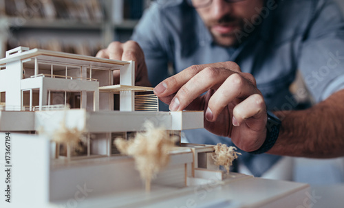 Architect hands making model house