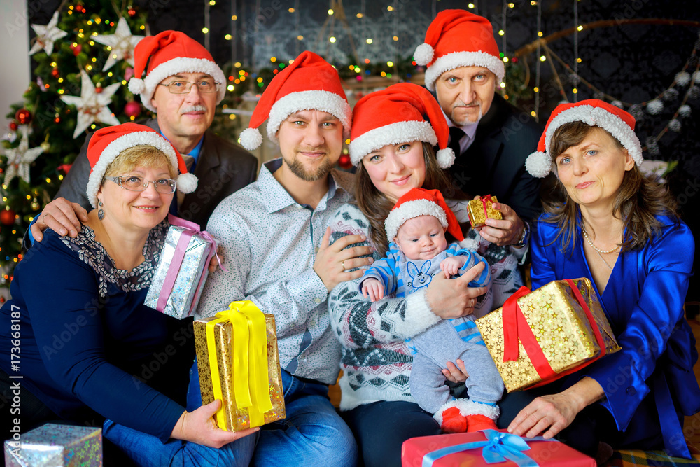 a large friendly family celebrates Christmas, give each other presents and have fun a large friendly family celebrates Christmas, give each other presents and have fun