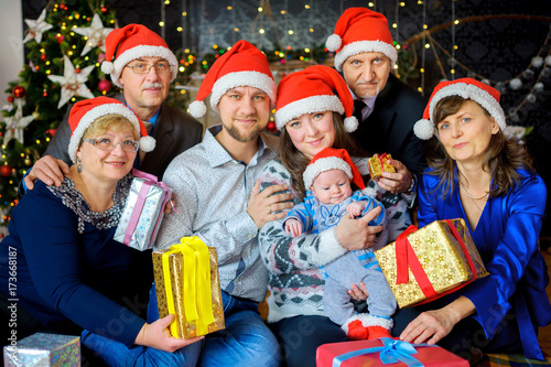 a large friendly family celebrates Christmas, give each other presents and have fun
