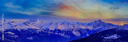 Scenic panorama sunset landscape of Crans-Montana range in Swiss Alps mountains with peak in background, Crans Montana, Switzerland. photo