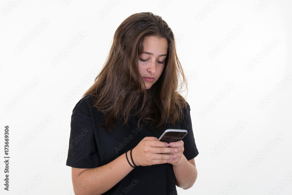 Happy beautiful young woman with long curly hair holding mobile phone over white background Happy beautiful young woman with long curly hair holding mobile phone over white background