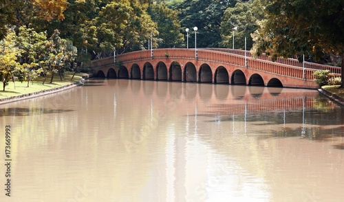 Arch brick bridge over the lake at Jatujak(Chatuchak) public city park photo