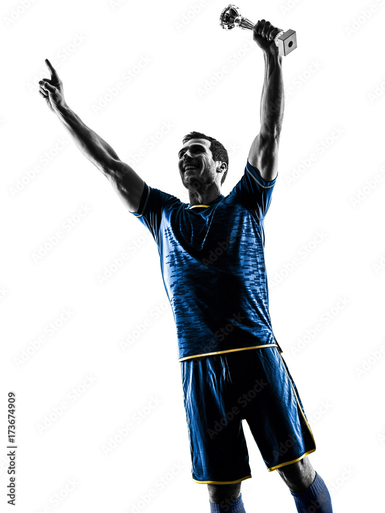 Obraz premium one caucasian soccer player man happy celebration trophy cup in silhouette isolated on white background