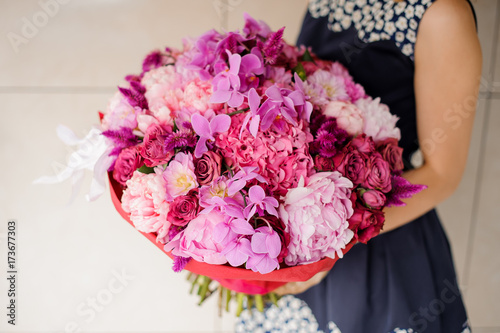Bright and beautiful bouquet of colorful flowers in hands