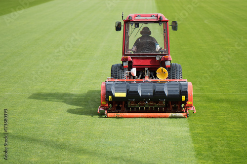 Man in tractor aerating a soccer field photo