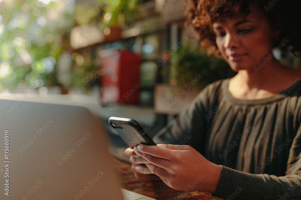 Woman looking at her mobile phone Woman looking at her mobile phone