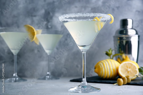Glasses of lemon drop martini with zest on table
