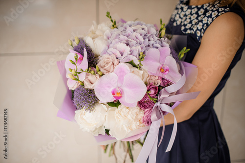 Wallpaper Mural Pretty and delicate bouquet of purple flowers in hands Torontodigital.ca