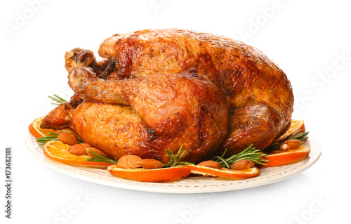 Plate with roasted turkey on white background