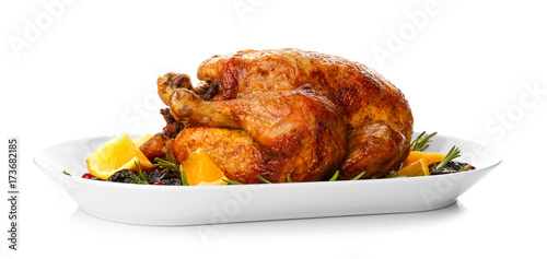 Plate with roasted turkey on white background photo