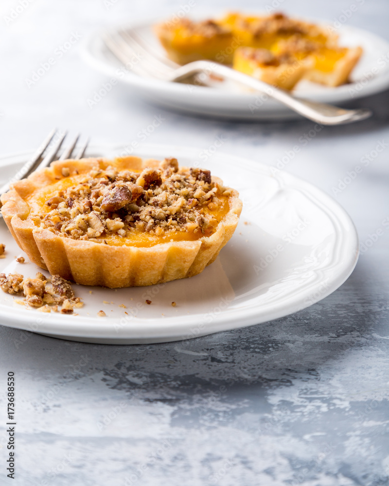 Pumpkin mini pie, tartlet made for Thanksgiving day on gray stone background. Healthy autumn food concept with copy space.