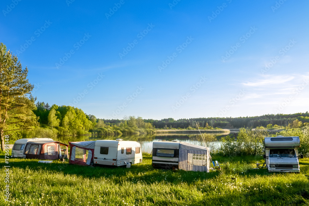 Caravans and camping on the lake. Family vacation outdoors, travel concept Caravans and camping on the lake. Family vacation outdoors, travel concept