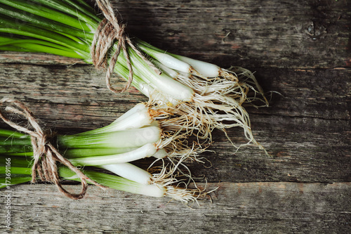 spring onion Isolated on wooden background