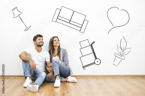 The happy man and woman dream near the wall with illustrations photo