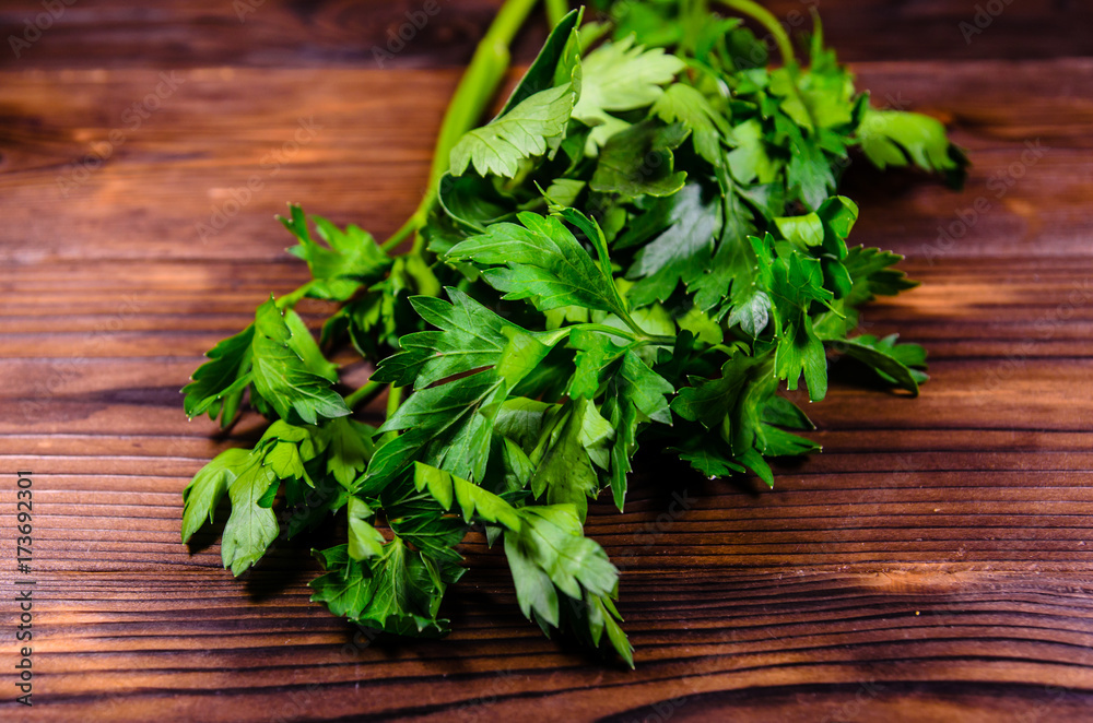 Bunch of parsley and dill on wooden table Bunch of parsley and dill on wooden table
