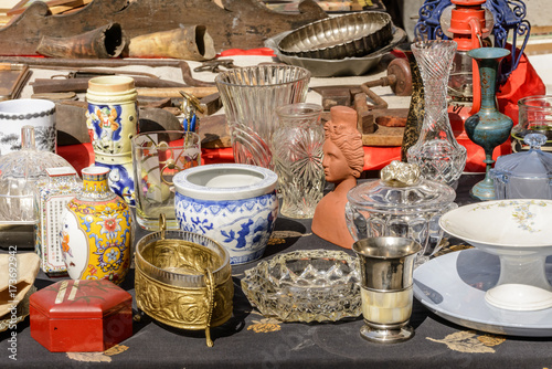 jumble of knick-knack and  trinkets on sale at street market, Chiavari, Italy