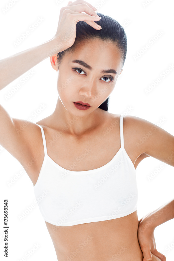 Obraz premium Half-body isolated portrait of sexy Asian woman in white top