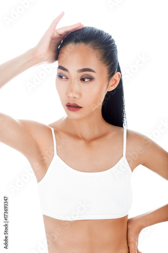 Half-body isolated portrait of sexy Asian woman in white top