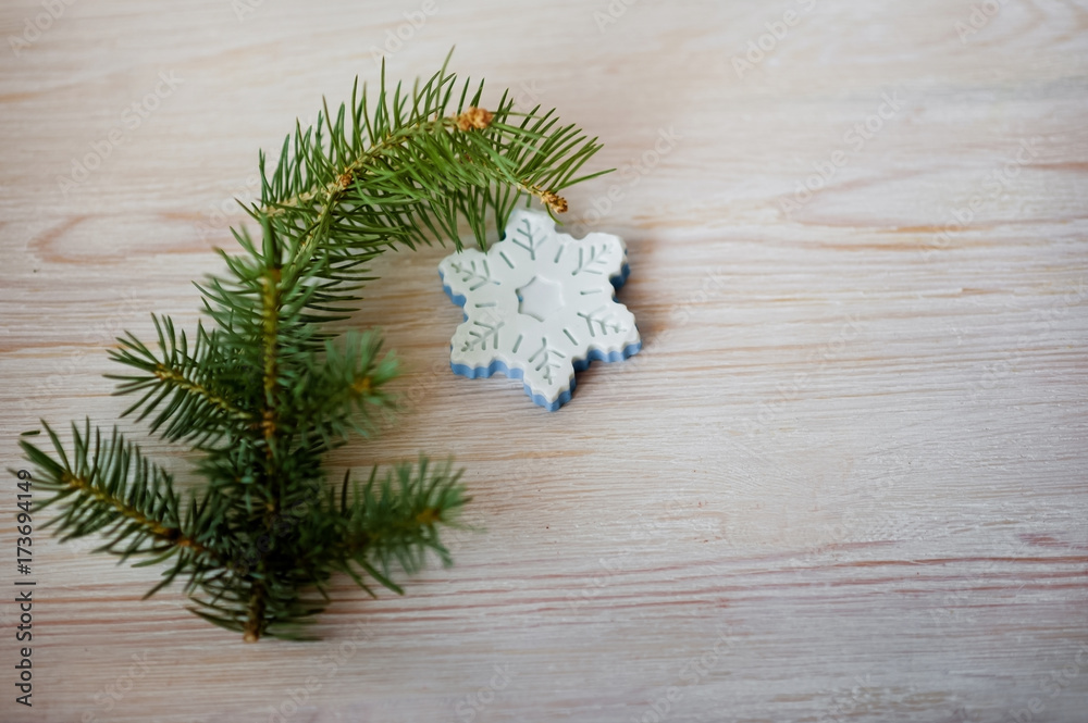Multicolored pieces of soap are tied with string. A beautiful white blue soap in the form of a snowflake with a sprig of spruce on a white wooden background. Multicolored pieces of soap are tied with string. A beautiful white blue soap in the form of a snowflake with a sprig of spruce on a white wooden background.