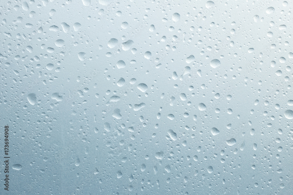 Light rain on the window glass, grainy texture on background Light rain on the window glass, grainy texture on background
