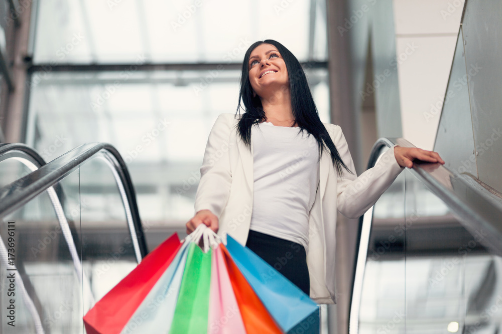 Beautiful woman leaving the mall with plenty of shopping bags Beautiful woman leaving the mall with plenty of shopping bags