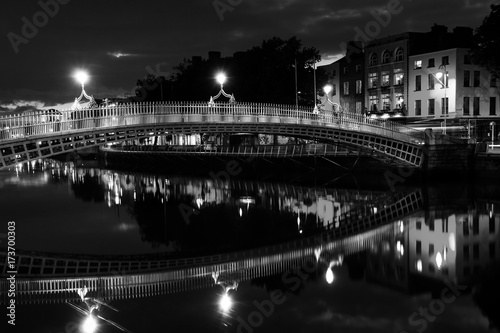 Ha Penny Bridge in Dublin, Ireland at night. Black and white