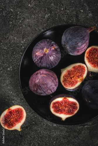 Raw fresh figs on dark stone background, copy space top view photo