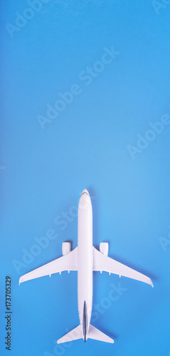 Model of passenger plane on blue background