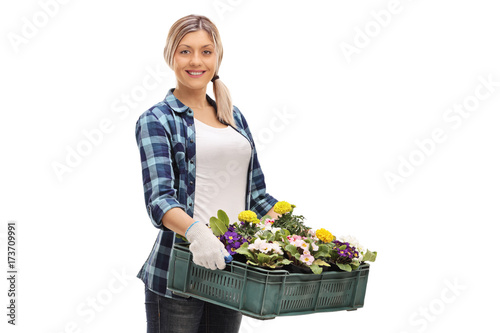 Canvas-taulu Female gardener with a crate full of flowers