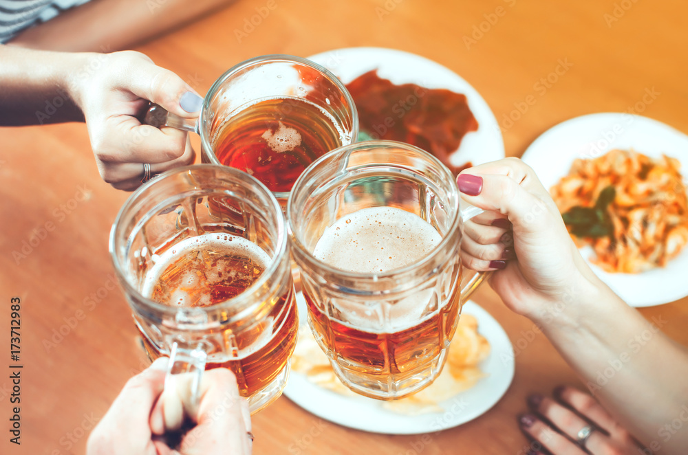 Beautiful beer in a mug holding friends Beautiful beer in a mug holding friends