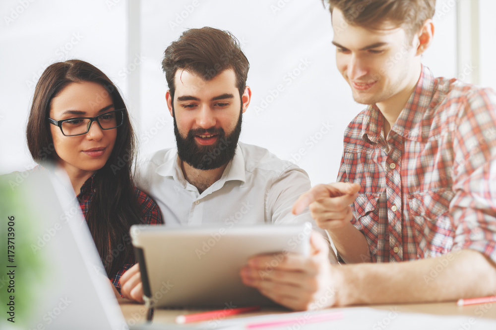 Focused people using tablet in office Focused people using tablet in office