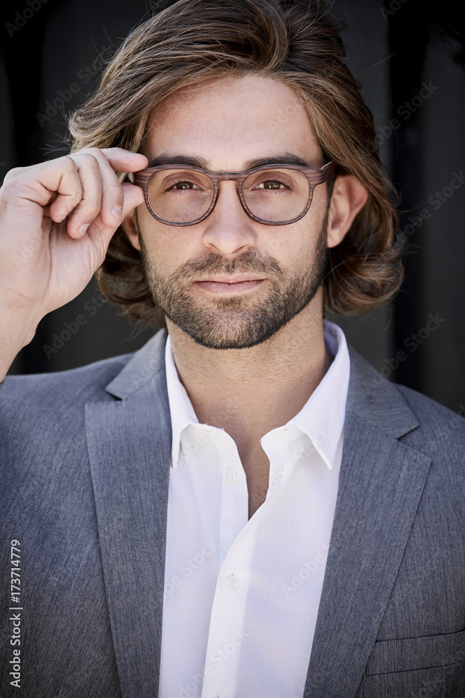 Handsome long hair guy in glasses, portrait Photos | Adobe Stock