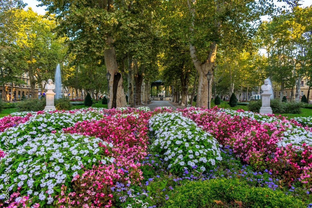 View across flowers of the green promenade and the old vintage pavilion in Zrinjevac park in Zagreb, Croatia 