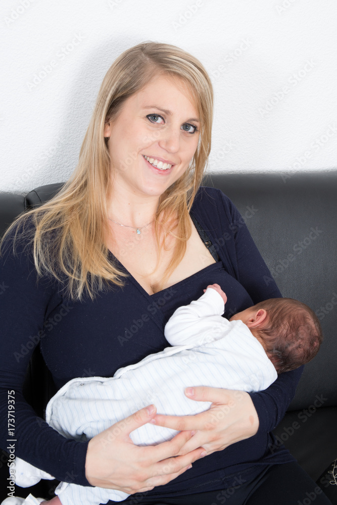 a mother breastfeeds her newborn child a mother breastfeeds her newborn child