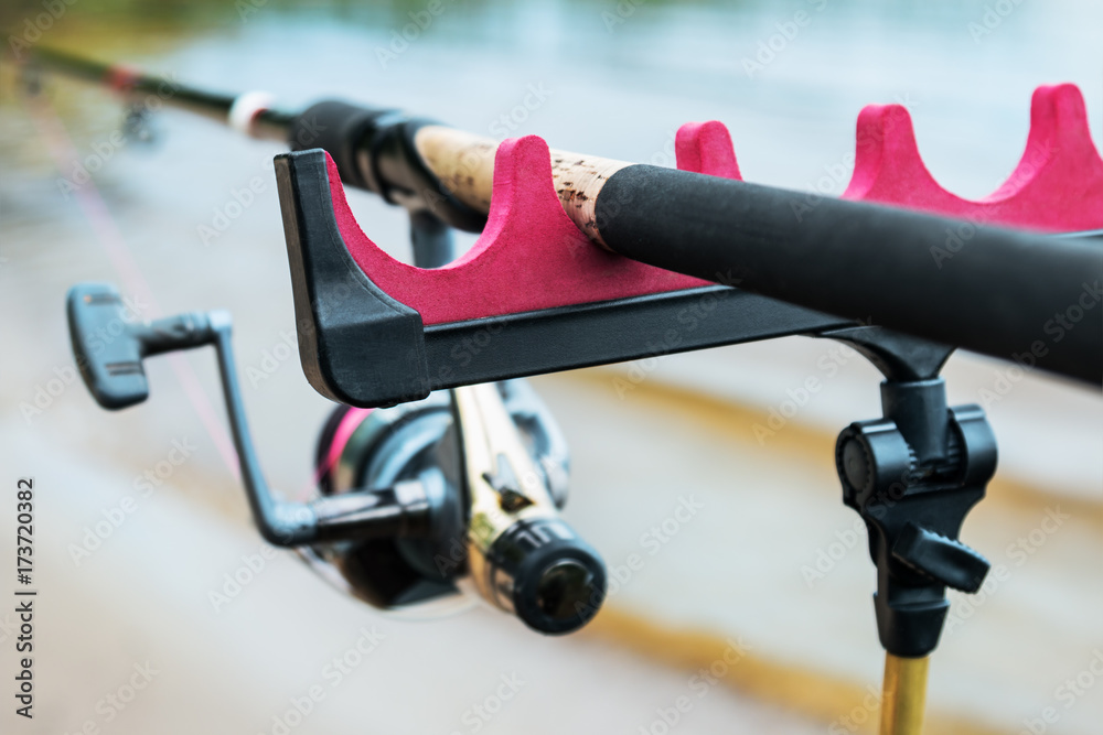 feeder fishing rod on the stand. Shallow depth of field, soft focus. Focus on the rod tip