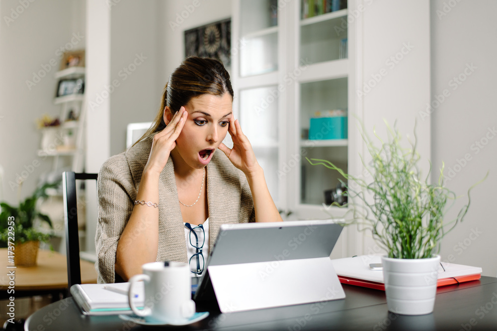 Casual worried woman working from home and suffering job issues. Female entrepreneur in trouble. Casual worried woman working from home and suffering job issues. Female entrepreneur in trouble.