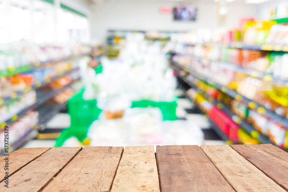 Wooden board empty table in front of blurred supermarket background