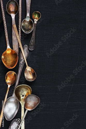 Background with old silver and gold various spoons