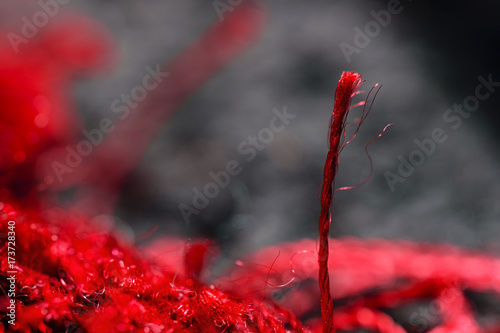 Extreme Close-Up Of One Vibrant Red Fiber Woven In Spiral