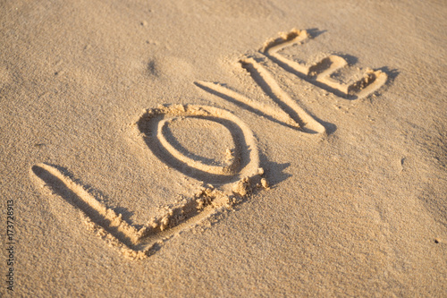 Fototapeta Naklejka Na Ścianę i Meble -  Inscription love on the sand on the beach of the Baltic Sea in summer: summer is almost gone, waiting for autumn.