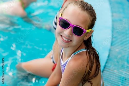 Beautiful girl in a swimsuit swims in the pool