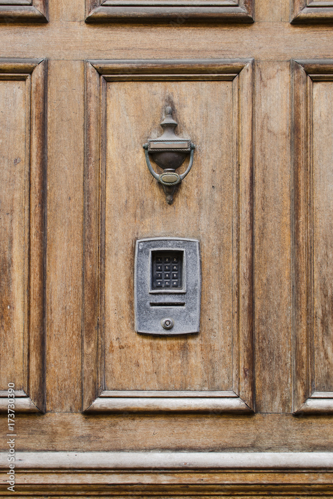 Vintage front wooden door with brass knocker and numlock digit lock