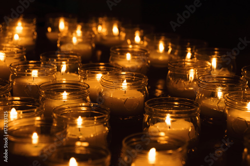 Group Of Candles Burning In Dimly Lit Room
