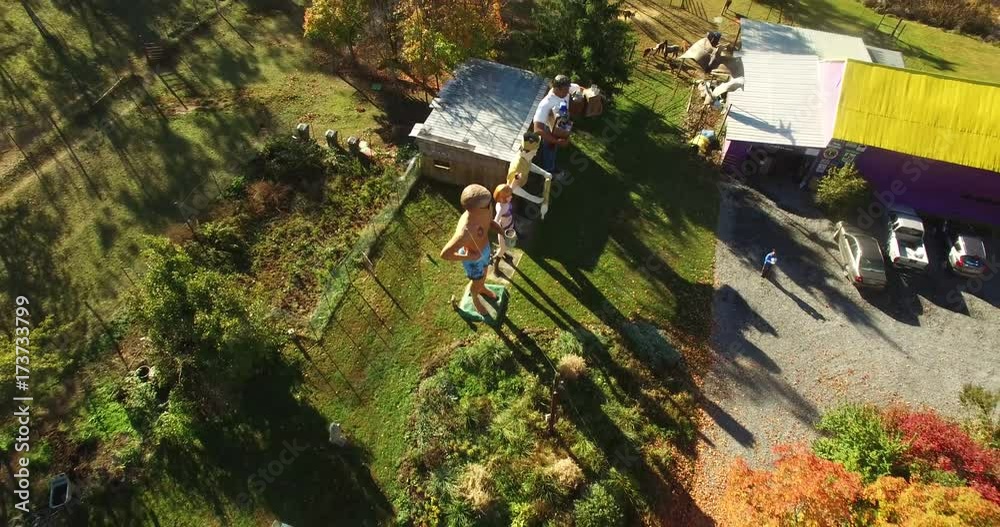 Camera starts overhead, pulls back and angles up to reveal giant American roadside attractions and oddities like Muffler Man, Brian Wilson the Beach Boy, Muffler Woman, and Grocery Man. Camera straigh