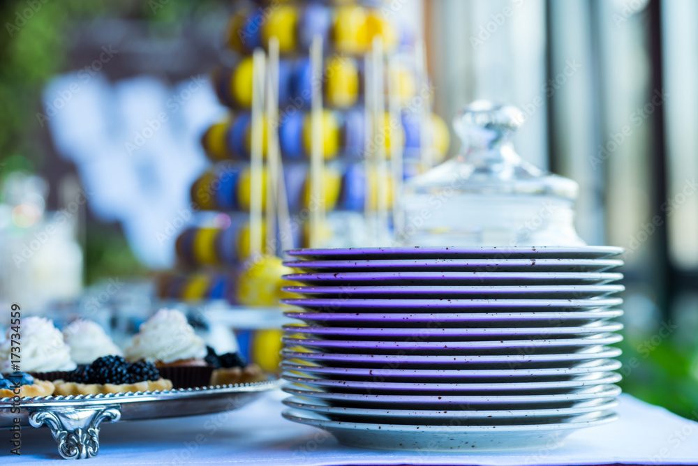 plates stacked on a table with sweets