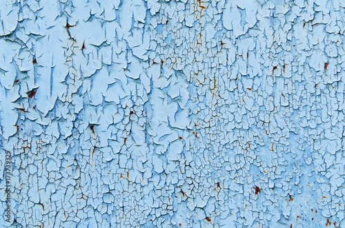Texture of vintage rusty blue and gray iron wall background with many layers of paint and rust